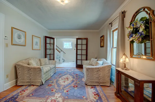 a view of a dining room with furniture and chandelier