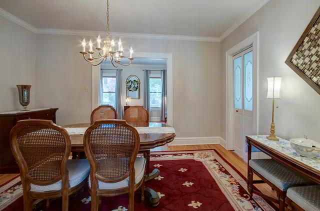 a dining room with a table chairs and a kitchen view