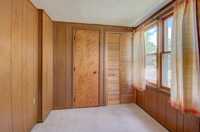a view of a room with a wooden door