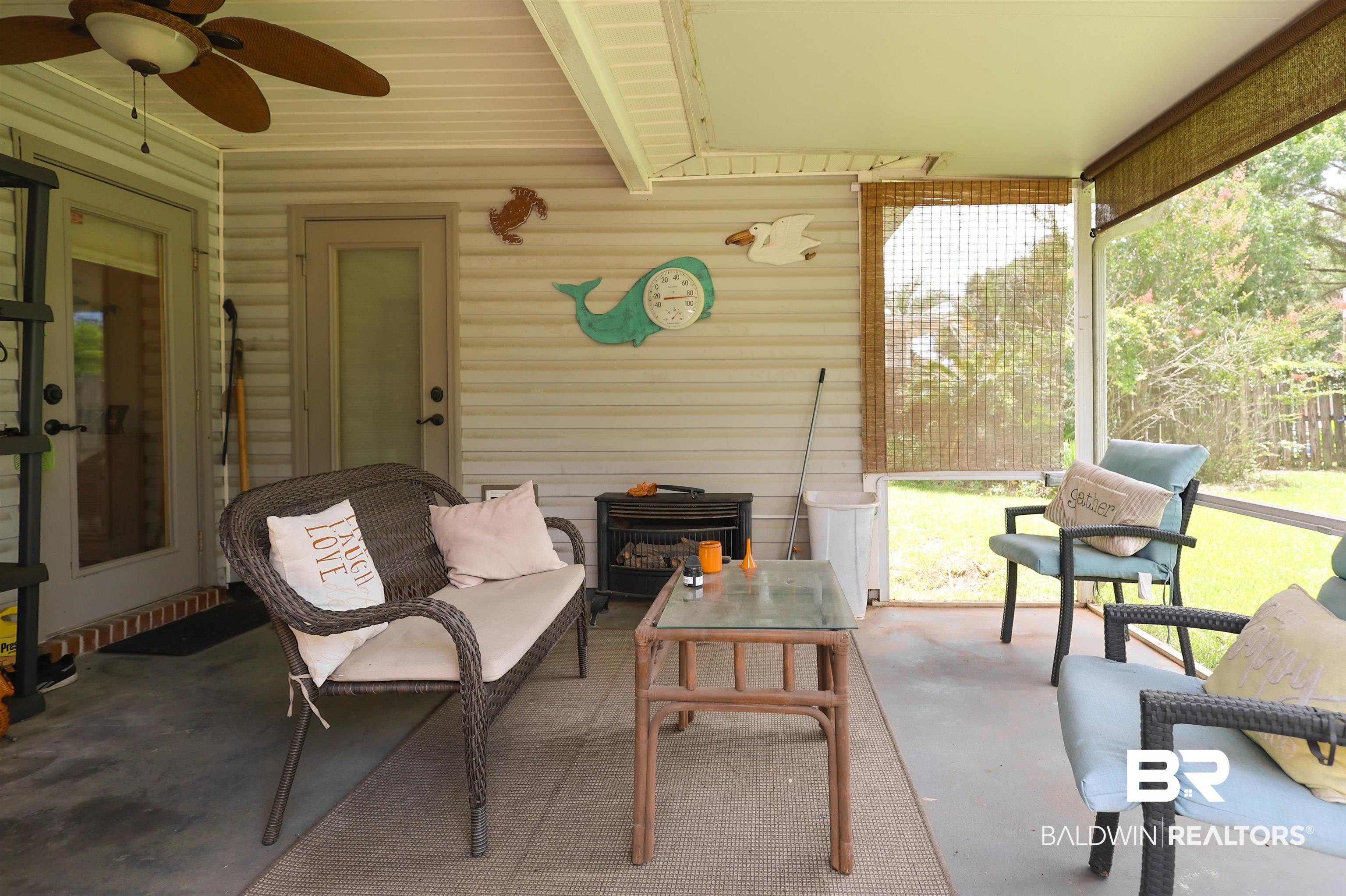 7790 Audubon Drive Foley, AL 36535 - Photo 35 of 39 Screened-in porch featuring a ceiling fan, concrete flooring, exterior siding, and a door with frosted glass