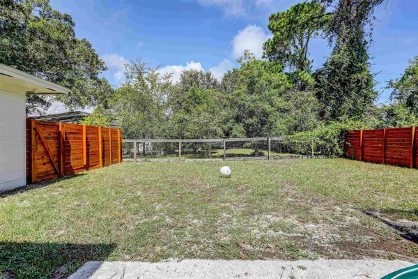 a view of a house with swimming pool and a yard