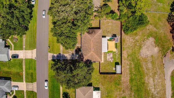 aerial view of a house with a yard