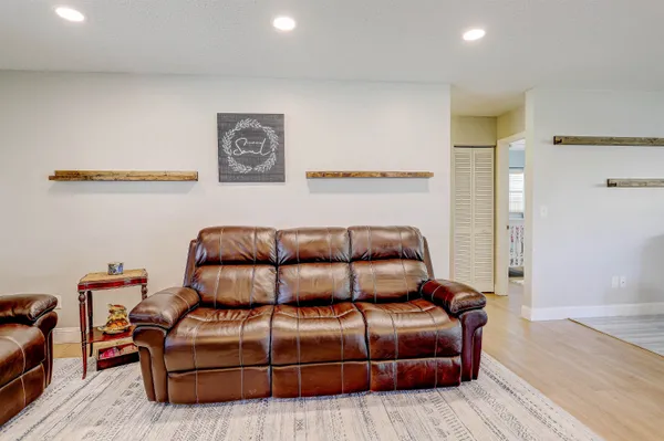 a living room with furniture fireplace and flat screen tv