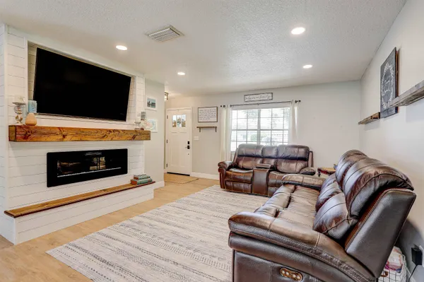 a living room with a flat screen tv and a fireplace