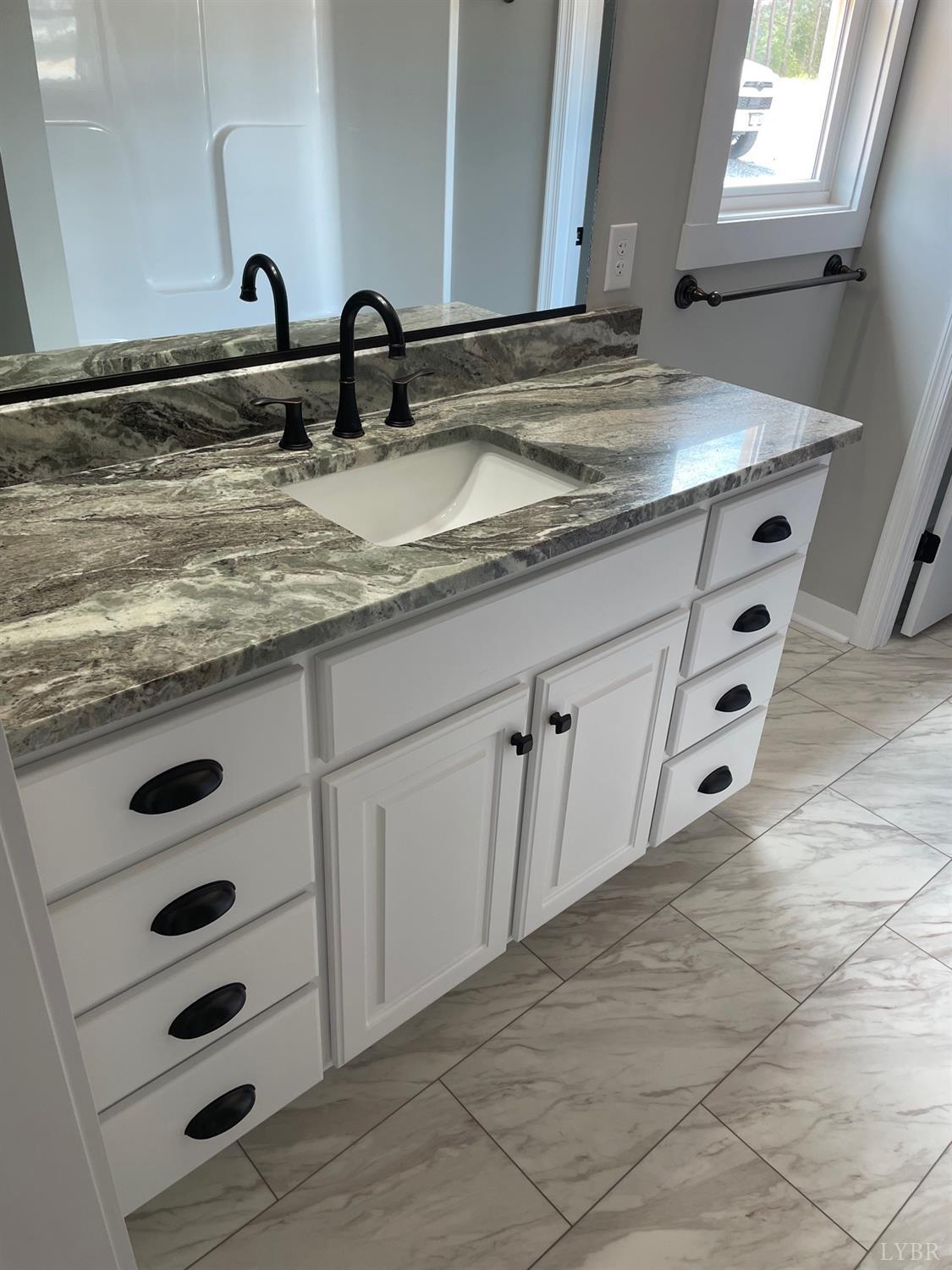 819 Winfall Road Rustburg, VA 24554 - Photo 13 of 15 a bathroom with a sink and a mirror