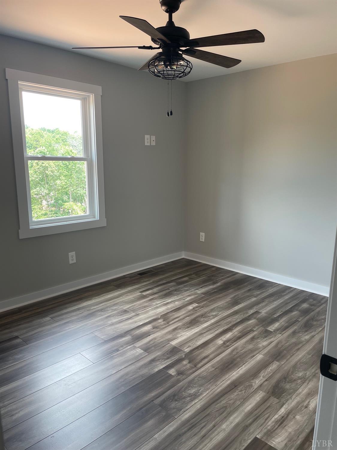 819 Winfall Road Rustburg, VA 24554 - Photo 14 of 15 an empty room with wooden floor closet and windows