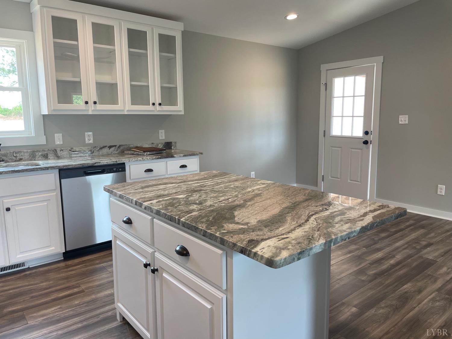819 Winfall Road Rustburg, VA 24554 - Photo 7 of 15 a kitchen with granite countertop a sink stove and cabinets