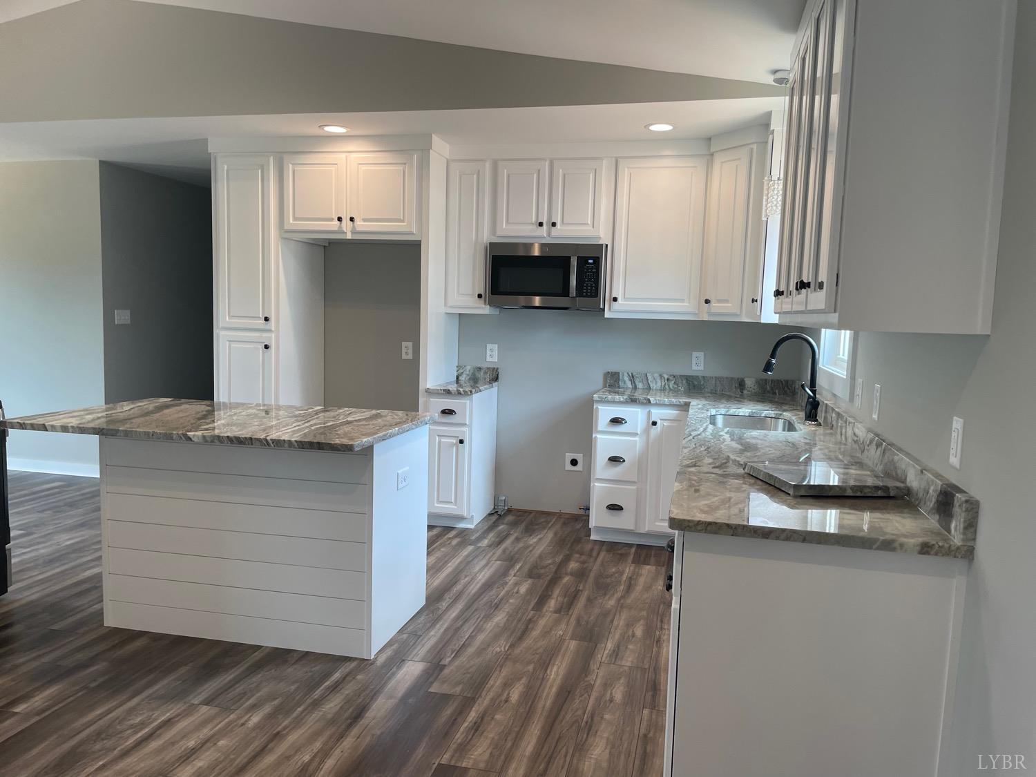 819 Winfall Road Rustburg, VA 24554 - Photo 8 of 15 a kitchen with granite countertop a sink and cabinets