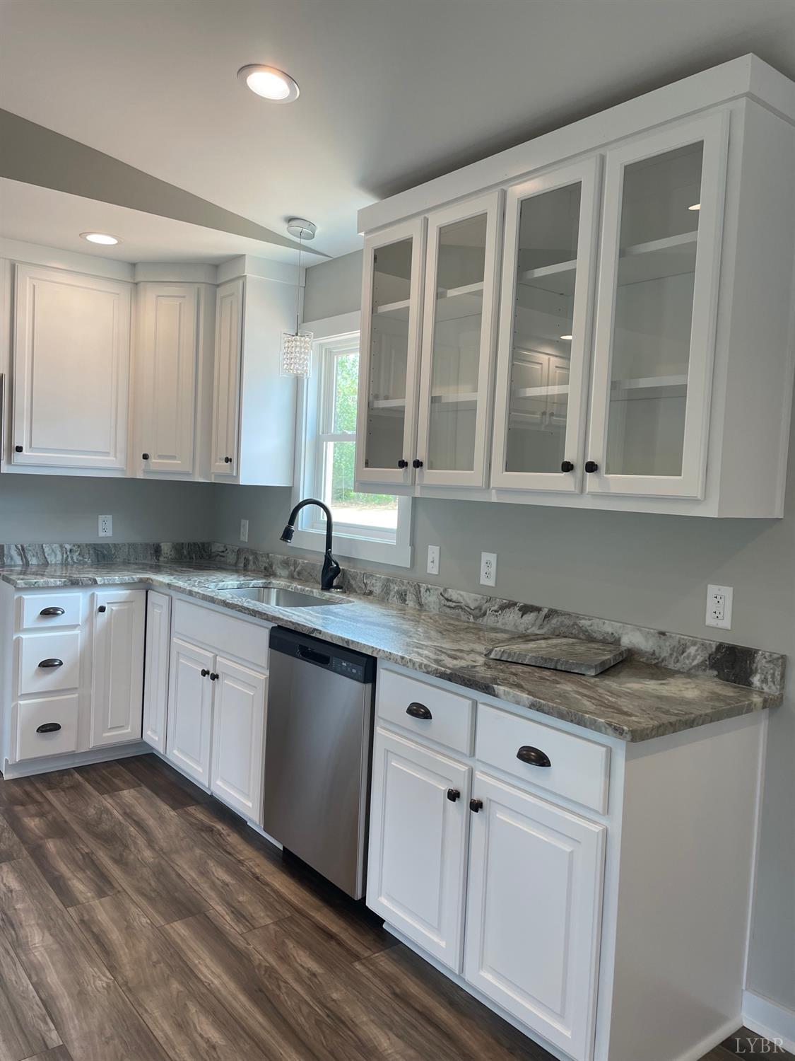 819 Winfall Road Rustburg, VA 24554 - Photo 9 of 15 a kitchen with granite countertop stainless steel appliances white cabinets granite counter tops and a wooden floors