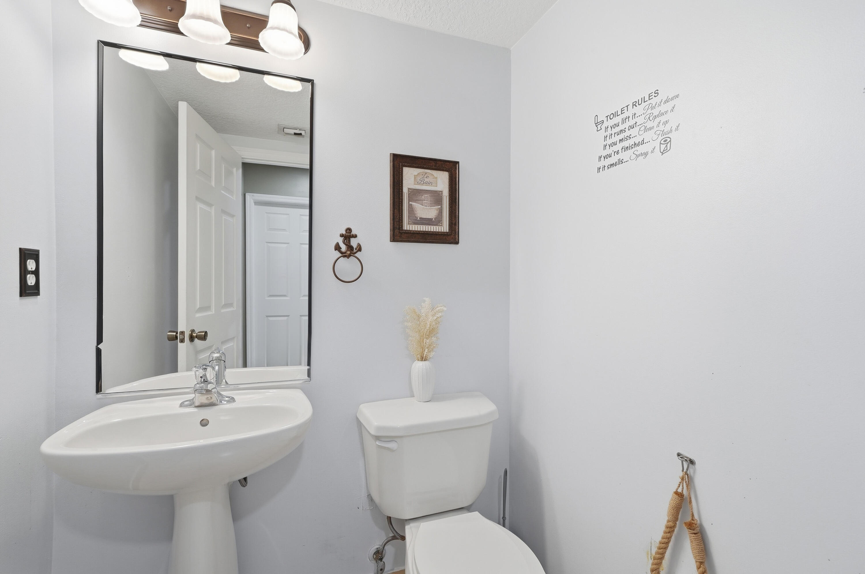 5825 Siena Lane Hollywood, FL 33021 - Photo 11 of 26 a bathroom with a toilet a sink and mirror