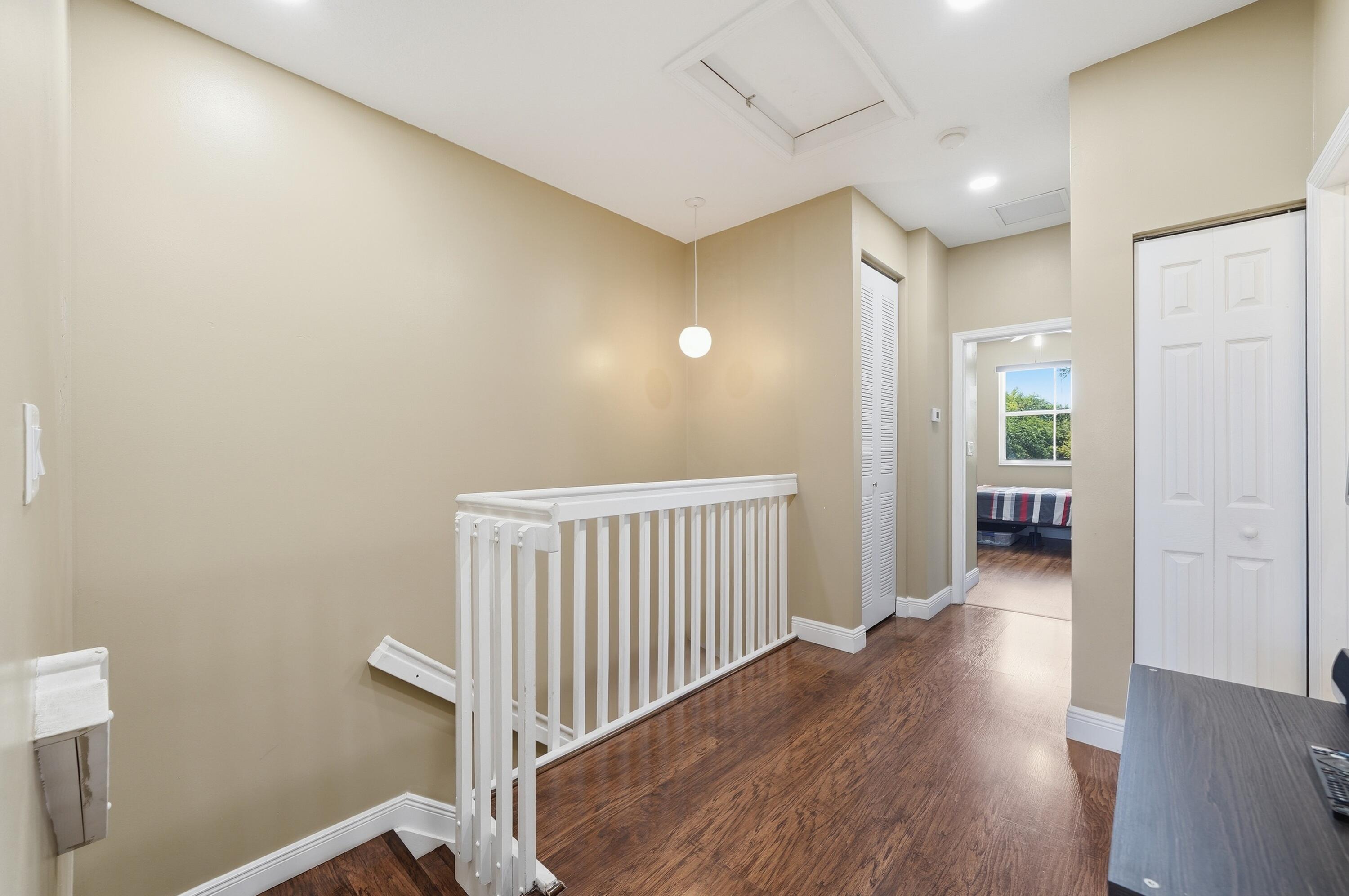 5825 Siena Lane Hollywood, FL 33021 - Photo 14 of 26 a view of a hallway with wooden floor and a bathroom