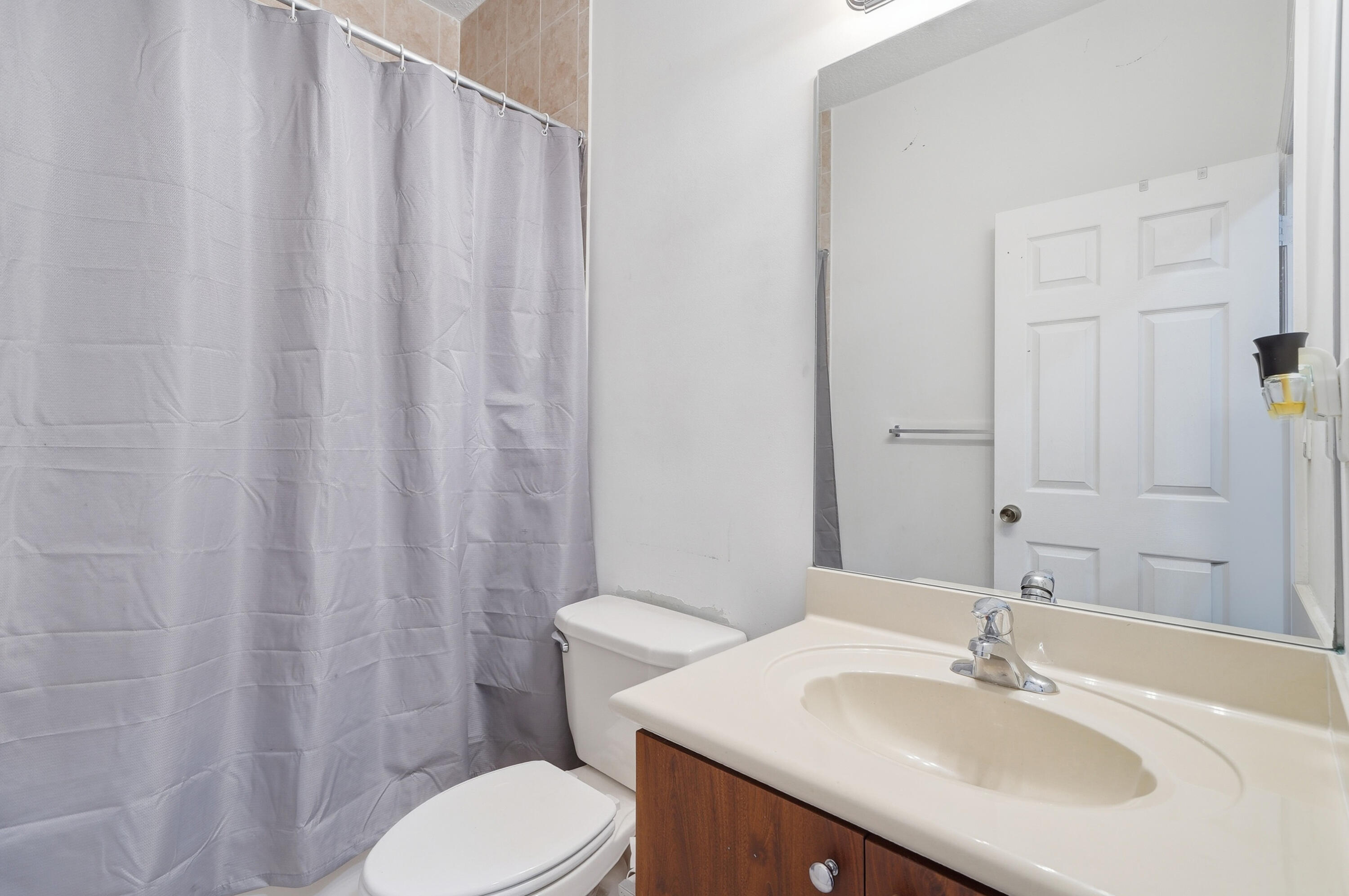 5825 Siena Lane Hollywood, FL 33021 - Photo 17 of 26 a bathroom with a sink a toilet and shower curtain