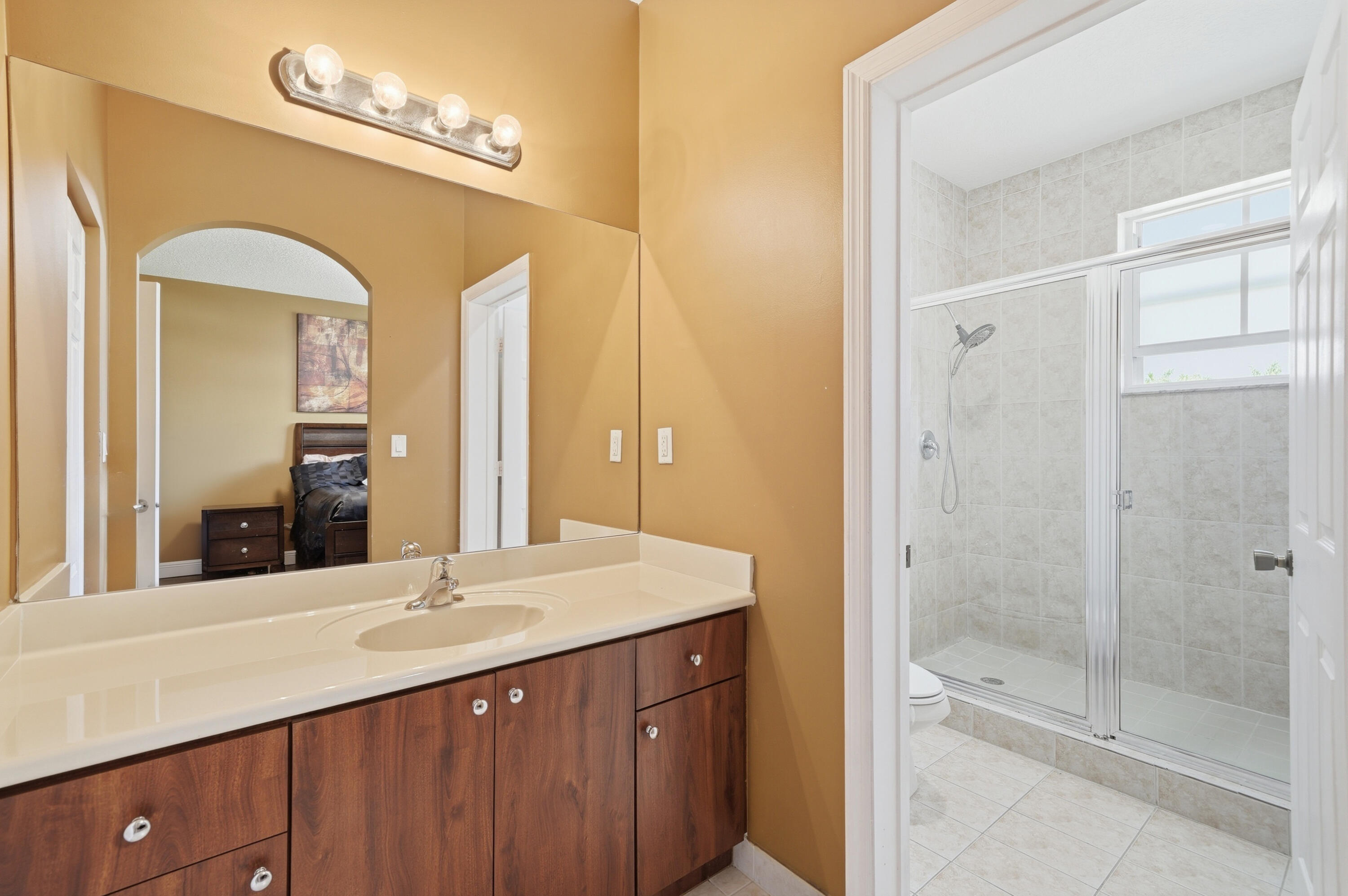 5825 Siena Lane Hollywood, FL 33021 - Photo 19 of 26 a bathroom with a shower sink and mirror