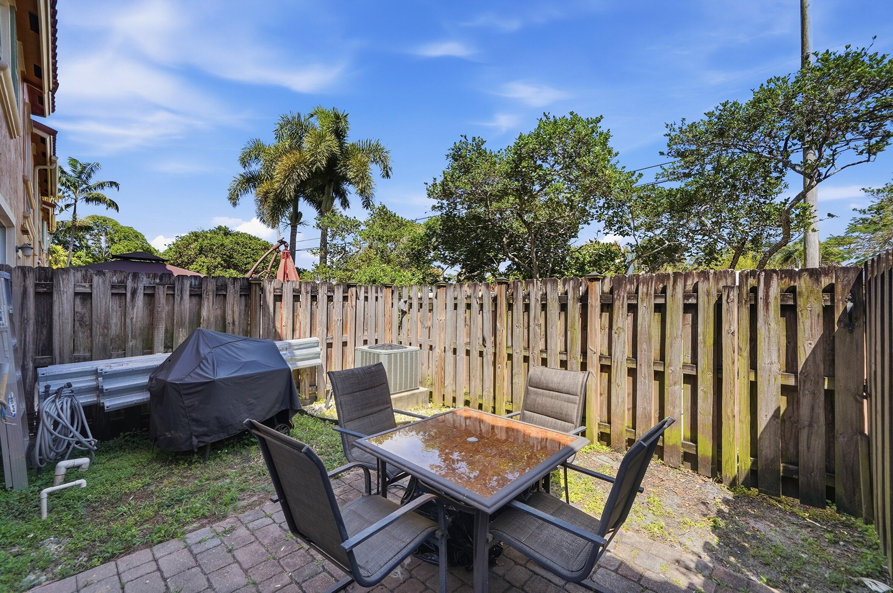 5825 Siena Lane Hollywood, FL 33021 - Photo 21 of 26 a backyard of a house with table and chairs