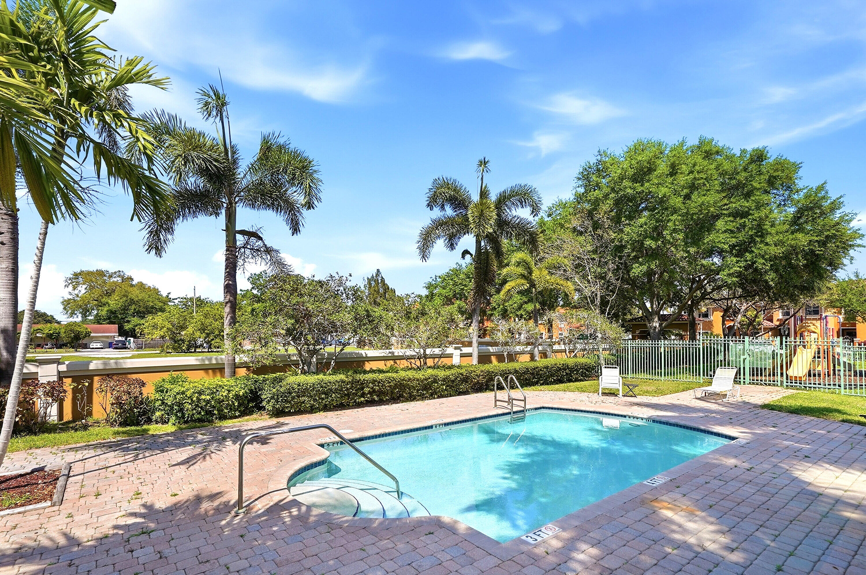 5825 Siena Lane Hollywood, FL 33021 - Photo 22 of 26 a view of a swimming pool and trees in the background