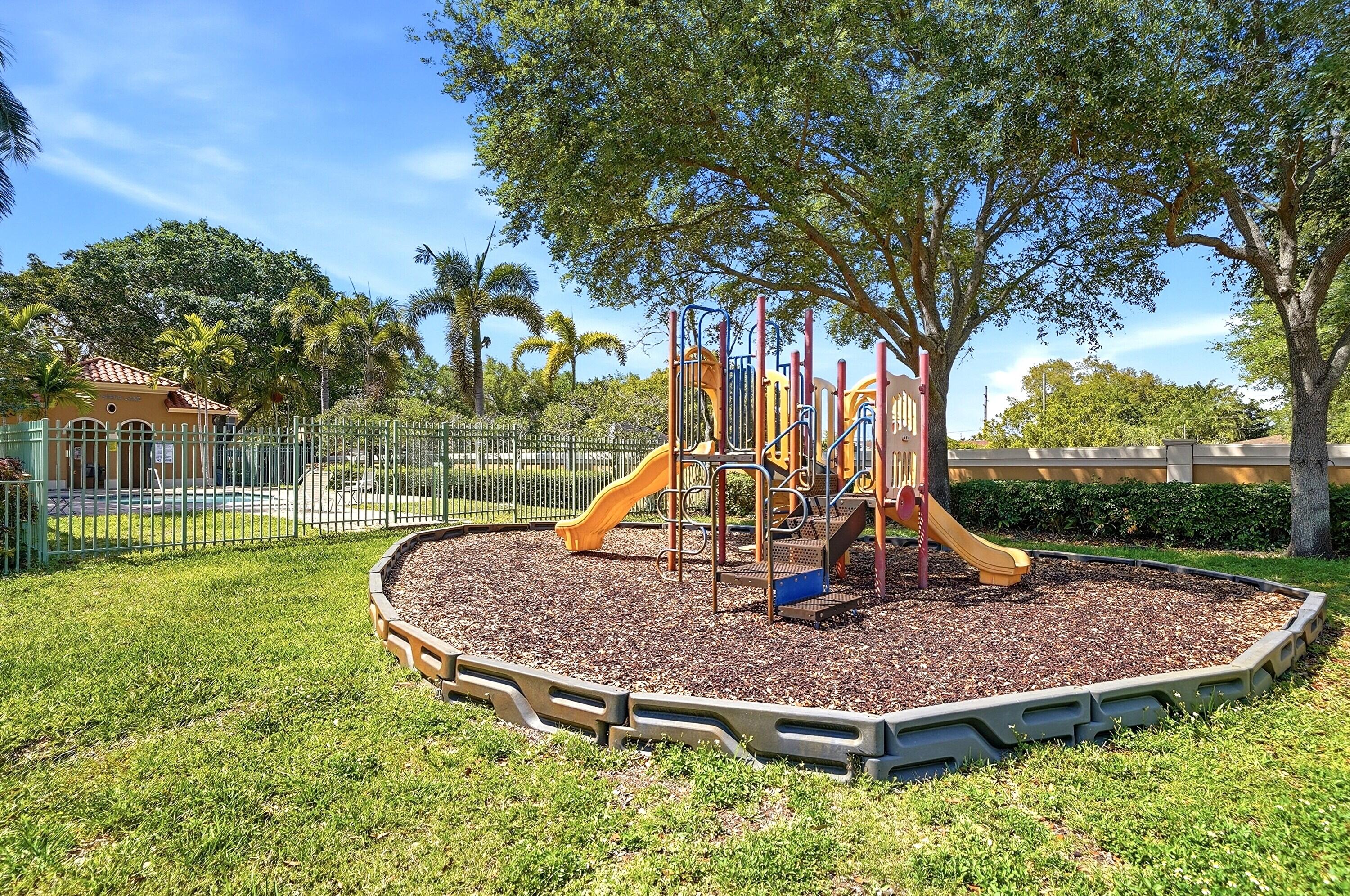 5825 Siena Lane Hollywood, FL 33021 - Photo 23 of 26 a view of a wooden house with a yard patio and fire pit
