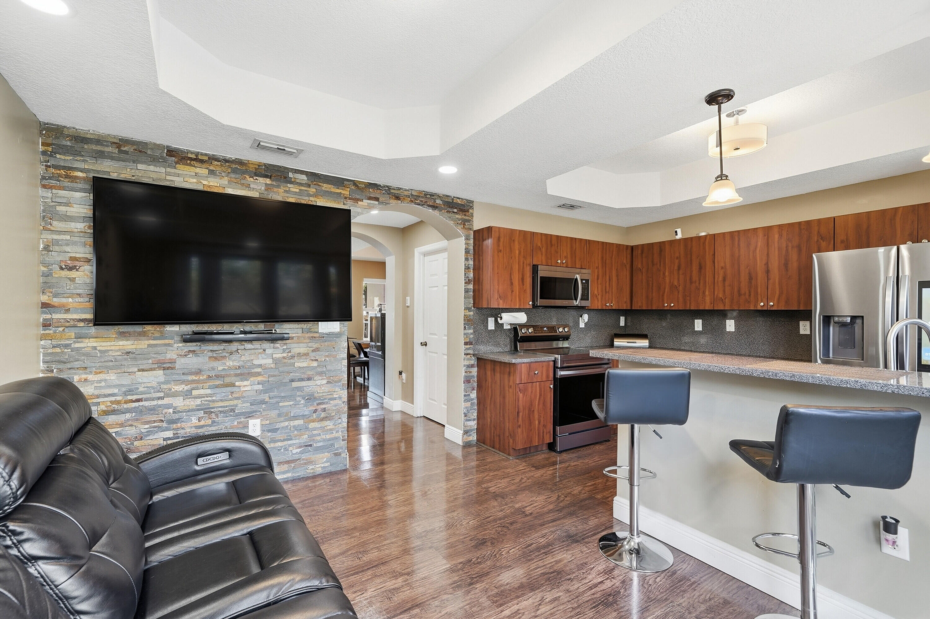 5825 Siena Lane Hollywood, FL 33021 - Photo 3 of 26 a living room with fireplace furniture and a flat screen tv