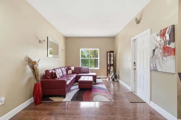 a living room with furniture window and a wooden floor