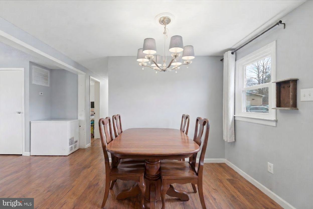 8513 Pamunkey Road Spotsylvania, VA 22551 - Photo 3 of 15 a view of a dining room with furniture and wooden floor