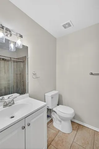 a bathroom with a sink a toilet and mirror
