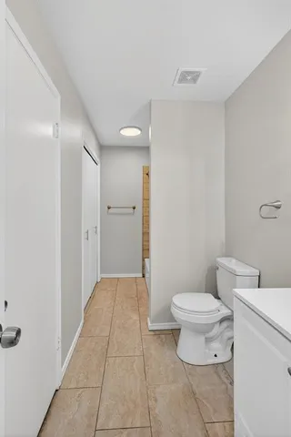 a bathroom with a toilet a sink and a shower