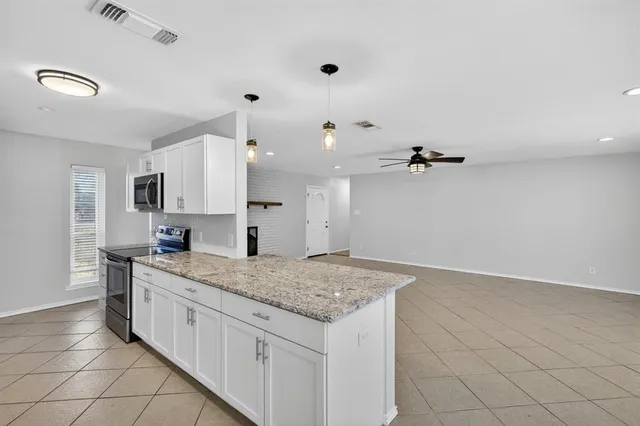 a view of a kitchen with a sink and wooden floor