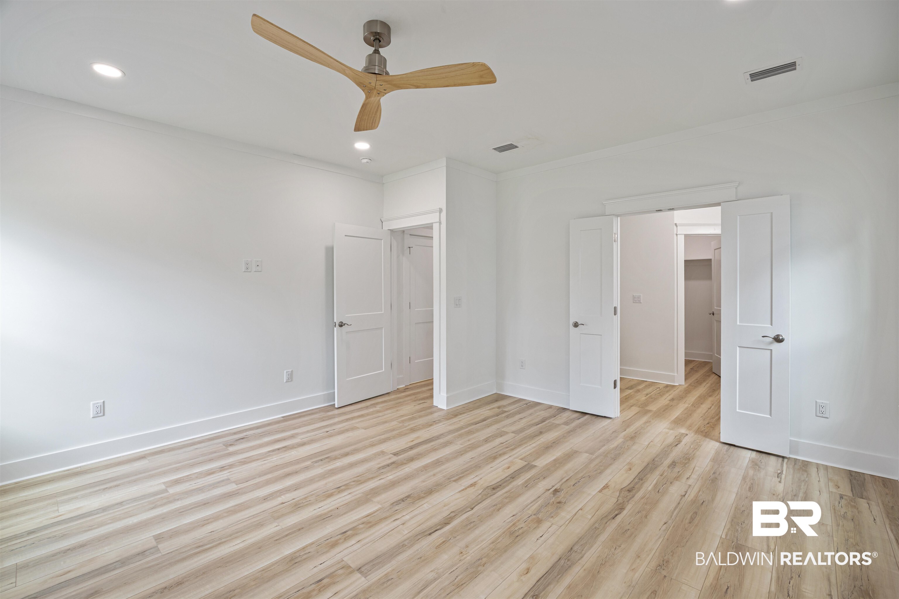 27591 Canal Road Orange Beach, AL 36561 - Photo 22 of 51 Unfurnished bedroom with light wood-type flooring, recessed lighting, crown molding, and a ceiling fan