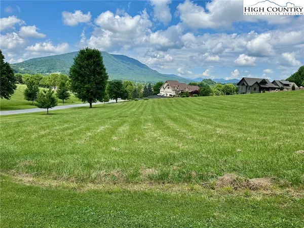 a front view of a house with a garden and sitting area