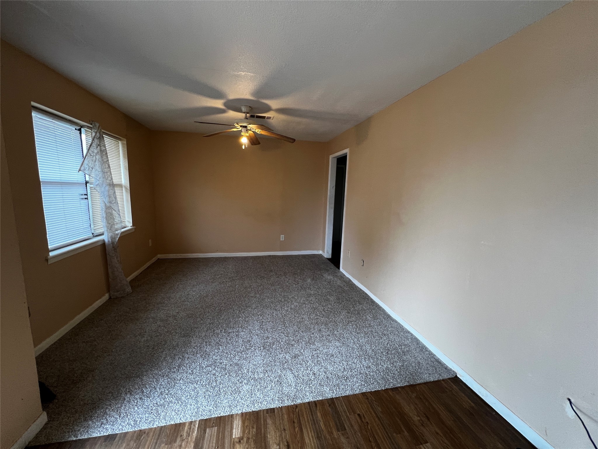 129 John Street Centerville, TX 75833 - Photo 6 of 15 an empty room with windows and fan
