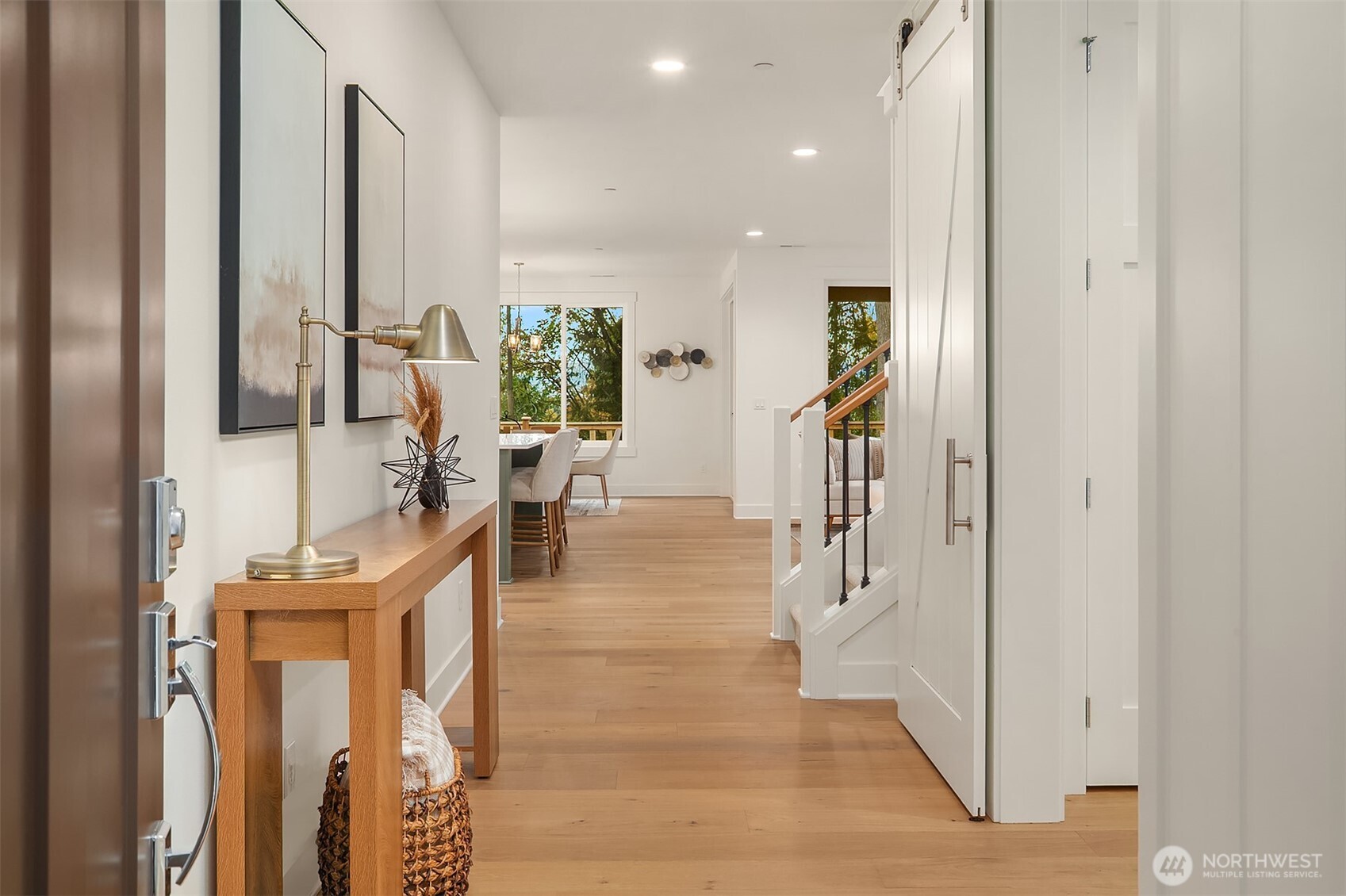 22212 98th Avenue West Edmonds, WA 98020 - Photo 3 of 39 a hallway with a dining table chairs and couches with wooden floor