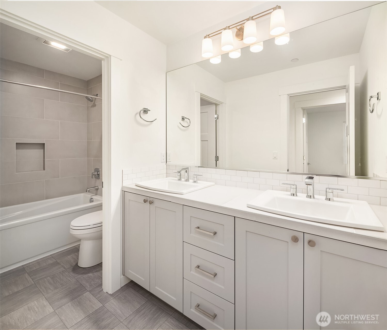 22212 98th Avenue West Edmonds, WA 98020 - Photo 33 of 39 a bathroom with a double vanity sink a toilet and a bathtub