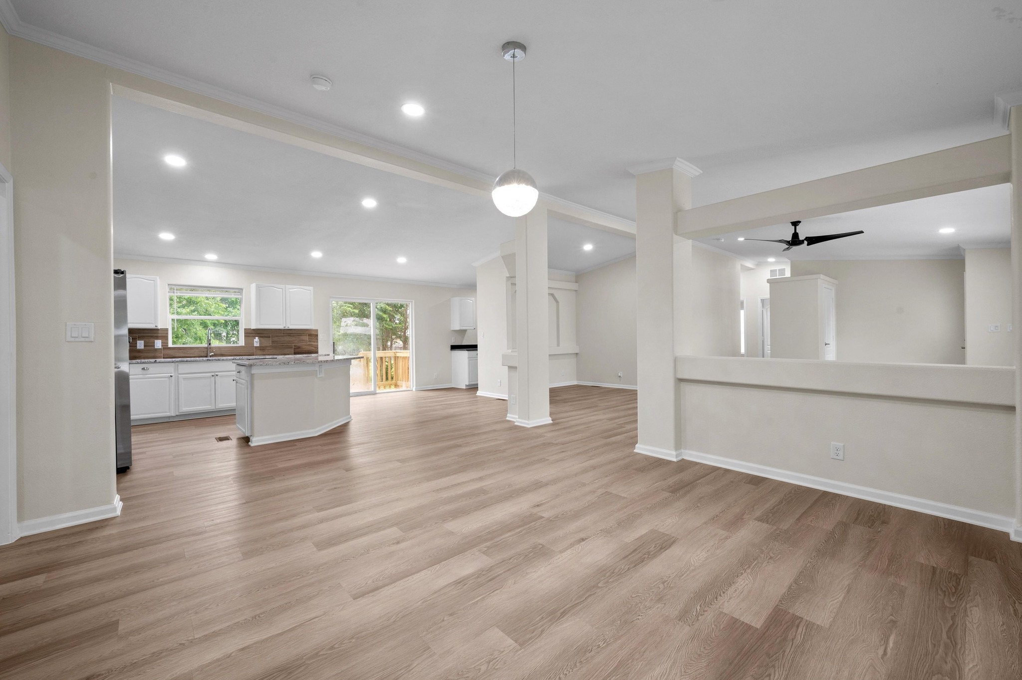 144 Quail Ridge Drive Kyle, TX 78640 - Photo 1 of 1 Unfurnished living room featuring ornamental molding, ceiling fan, light wood-style floors, recessed lighting, and baseboards