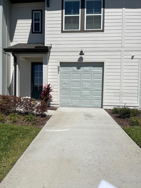 921 Conch Road Davenport, FL 33896 - Photo 2 of 21 a front view of a house with a garden