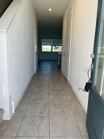 a view of hallway with a window and fire place