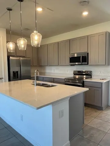 a kitchen with a cabinets and chandelier