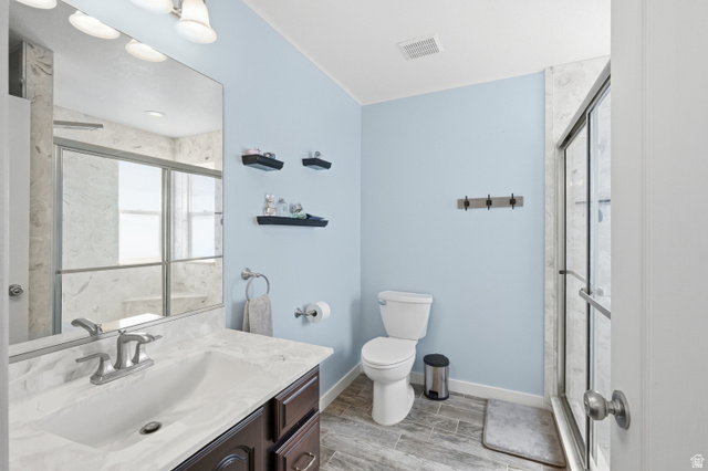 860 West 2980th Street South Logan, UT 84321 - Photo 18 of 38 Bathroom featuring a dark wood-finish vanity with a light-colored countertop, an integrated sink, and a brushed nickel faucet