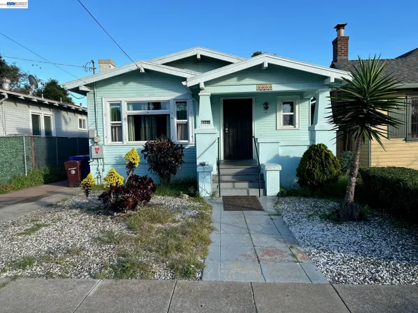 a front view of a house with yard and furniture