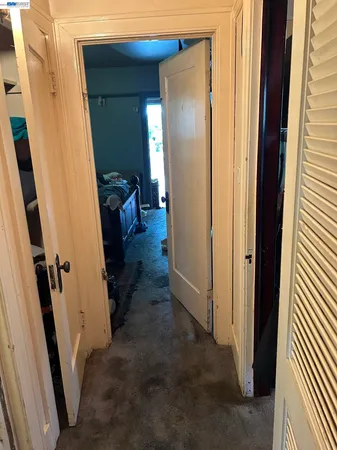 a view of a hallway with entryway and a rug