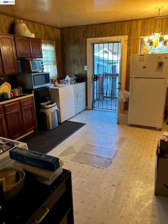 a kitchen with a refrigerator and a stove top oven
