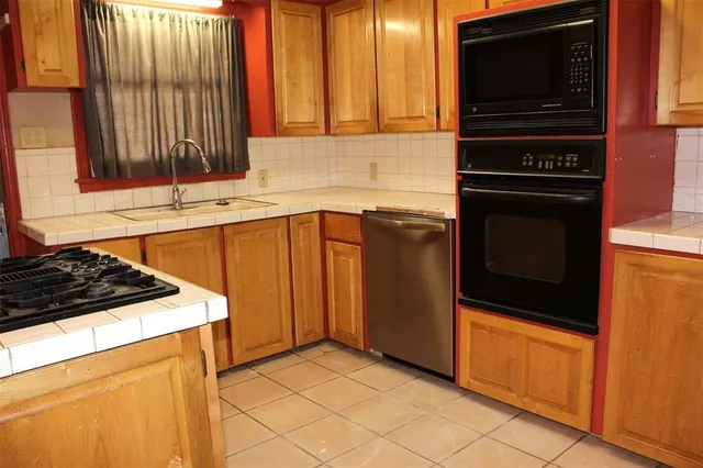 a kitchen with wooden cabinets and a stove top oven