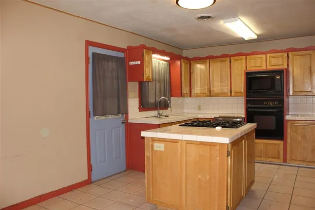 a kitchen with a stove and a refrigerator