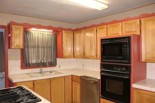 a kitchen that has a sink and a stove