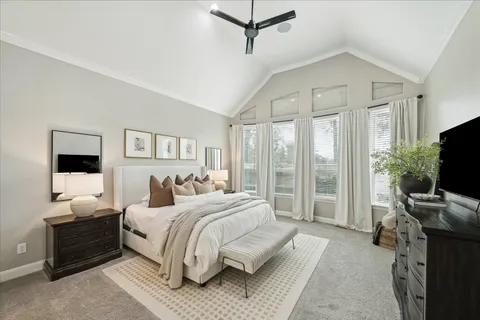 a bedroom with a large bed and a window