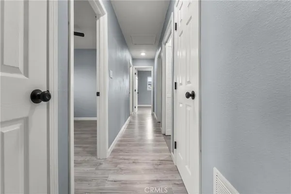 a view of a hallway with wooden floor