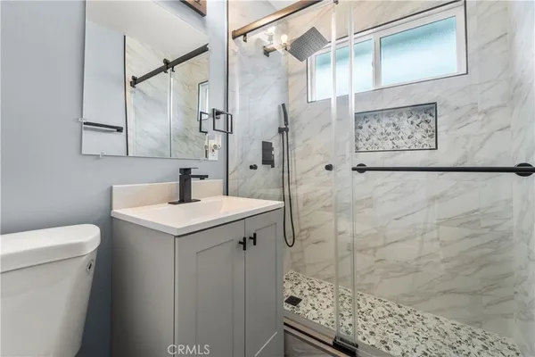 a bathroom with a sink toilet and shower