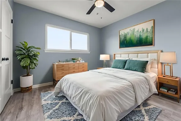 a bedroom with a bed and a potted plant