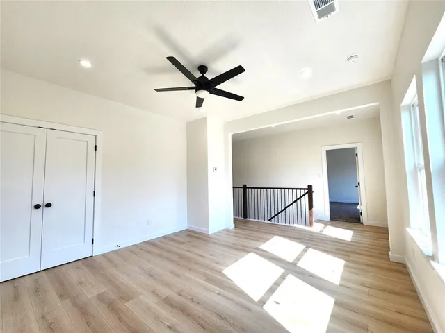 a view of a livingroom with a ceiling fan and wooden floor