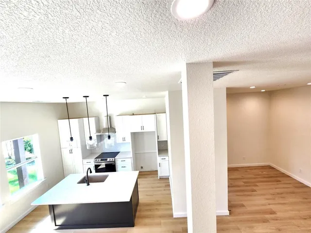 a view of living room with furniture and wooden floor