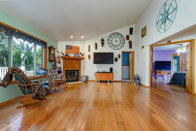 a view of a livingroom with furniture a flat screen tv and a fireplace
