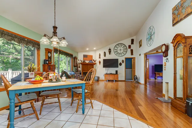 a view of a dining room with furniture a chandelier and wooden floor